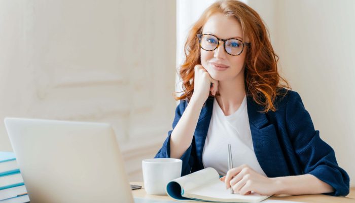 redhead-curly-woman-office-worker-analyzes-data-m-2021-08-30-14-12-07-utc.jpg